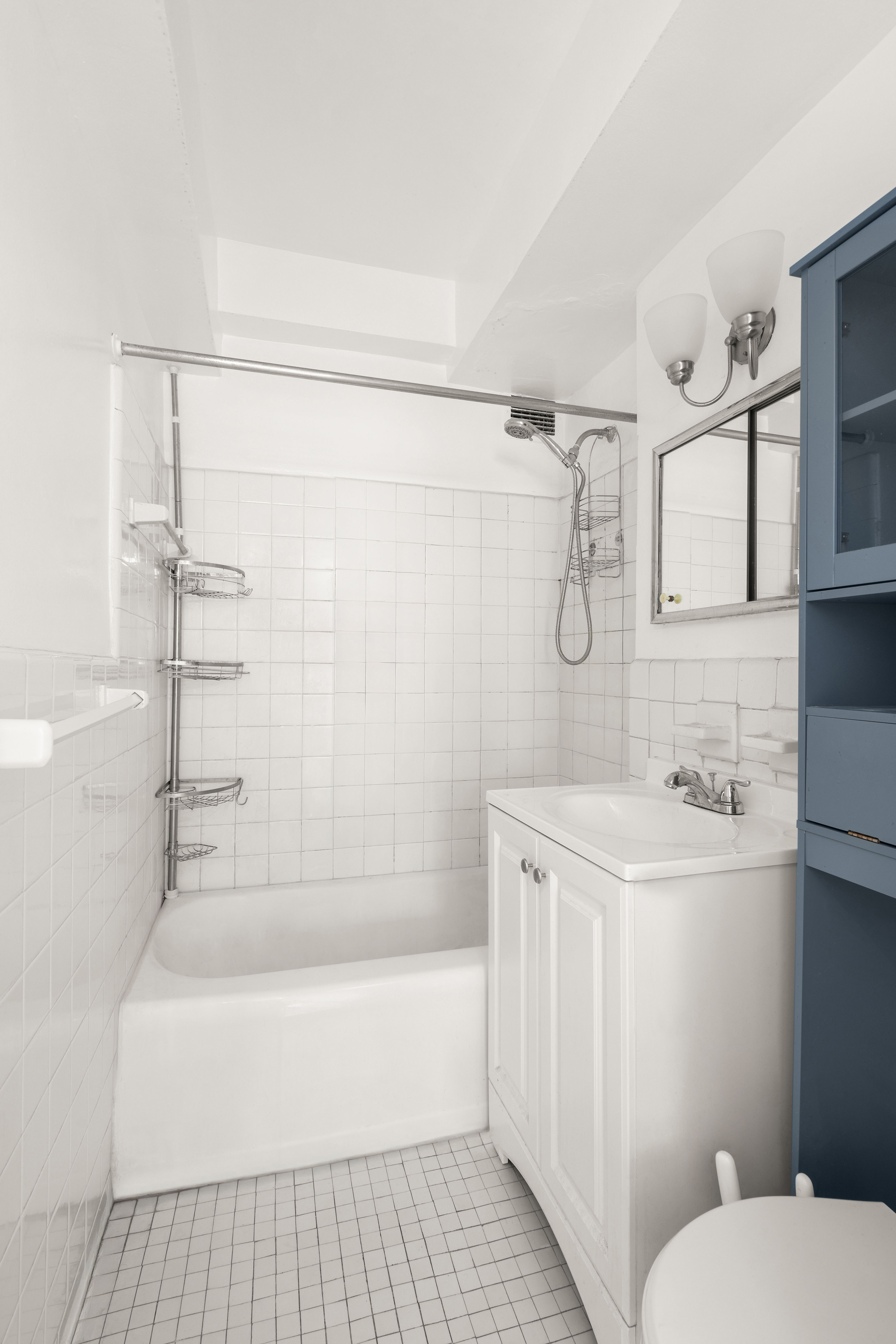 249 East 48th Street, Unit 12A Manhattan, NY 10017 - Photo 6 of 9 a bathroom with a sink a toilet and shower