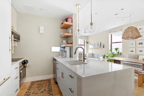 a kitchen with sink cabinets and window