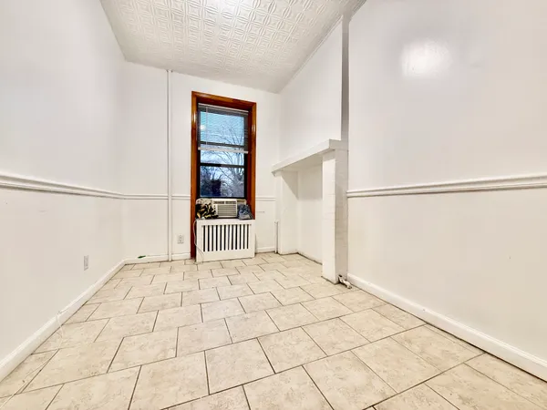 a view of a bedroom with wooden floor and entryway