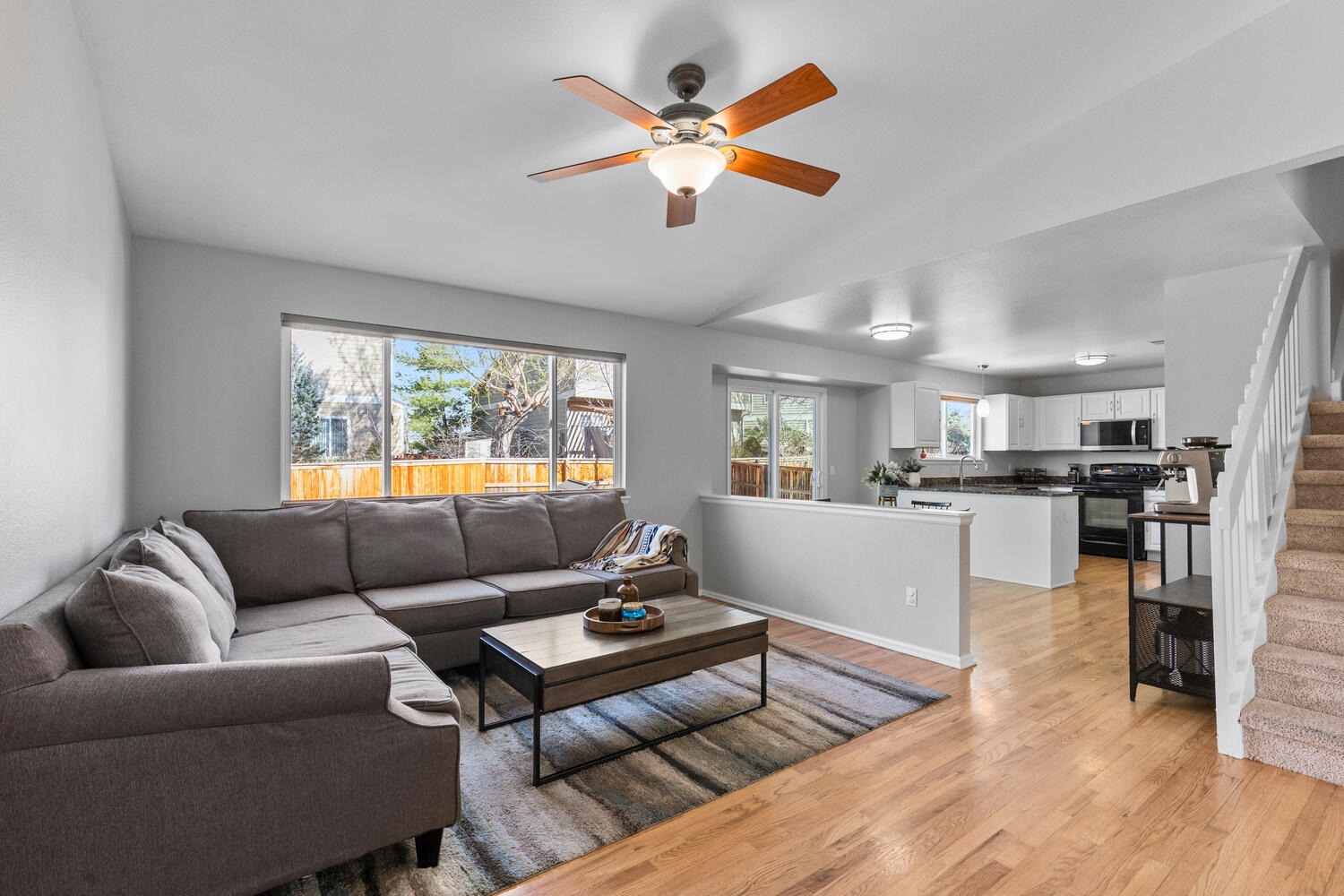 847 Timbervale Trail Highlands Ranch, CO 80129 - Photo 7 of 36 a living room with furniture and kitchen view