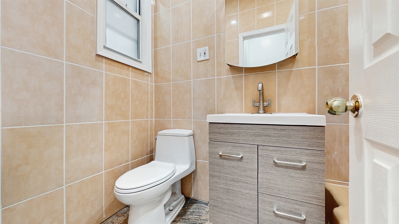 454 77th Street, Unit 3 Brooklyn, NY 11209 - Photo 23 of 25 a bathroom with a toilet sink and mirror