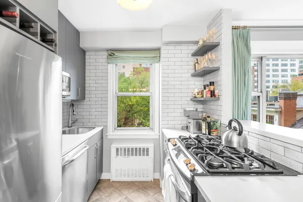 a kitchen with a stove a sink and a refrigerator