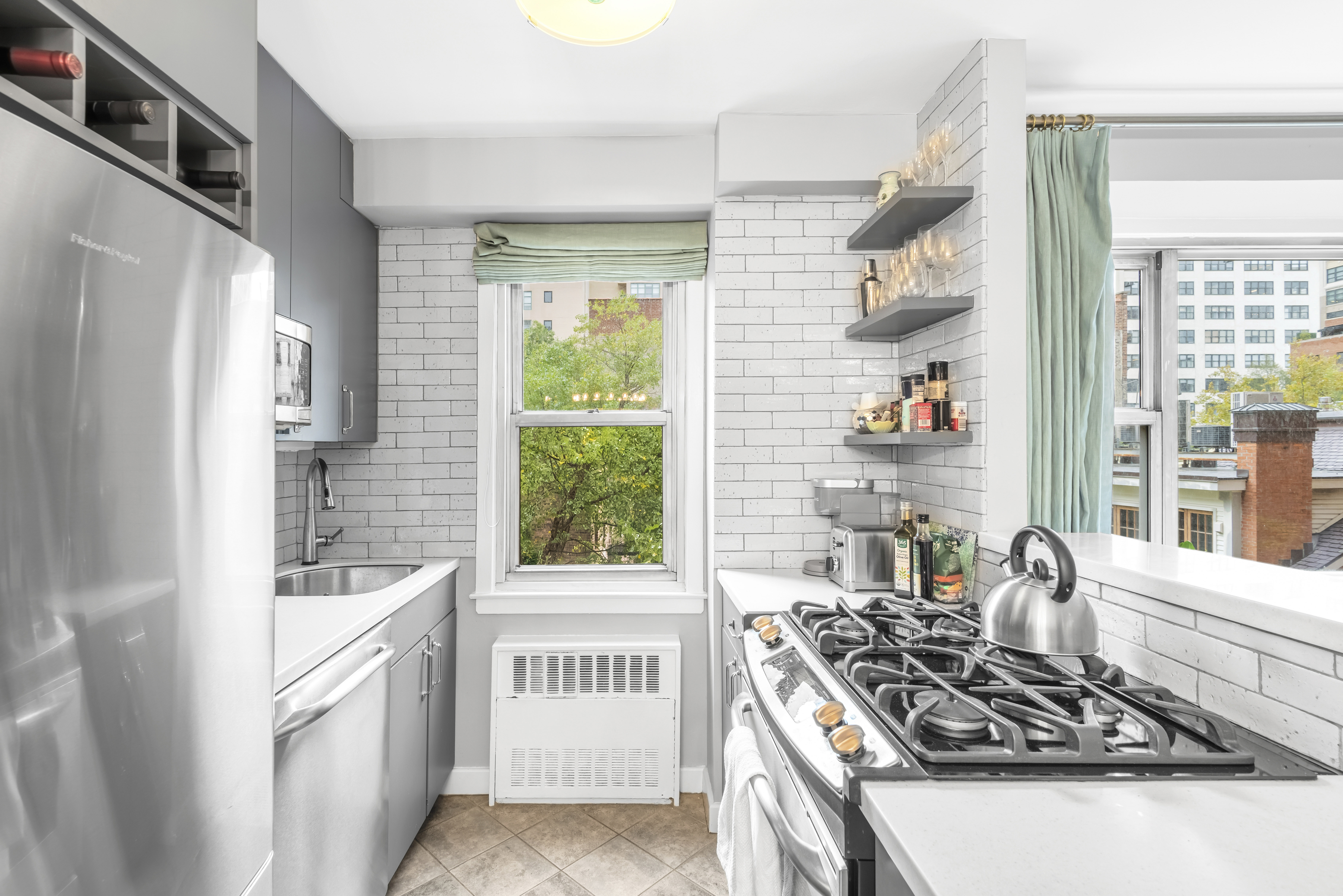 2 Charlton Street, Unit 5A Manhattan, NY 10014 - Photo 4 of 12 a kitchen with a stove a sink and a refrigerator