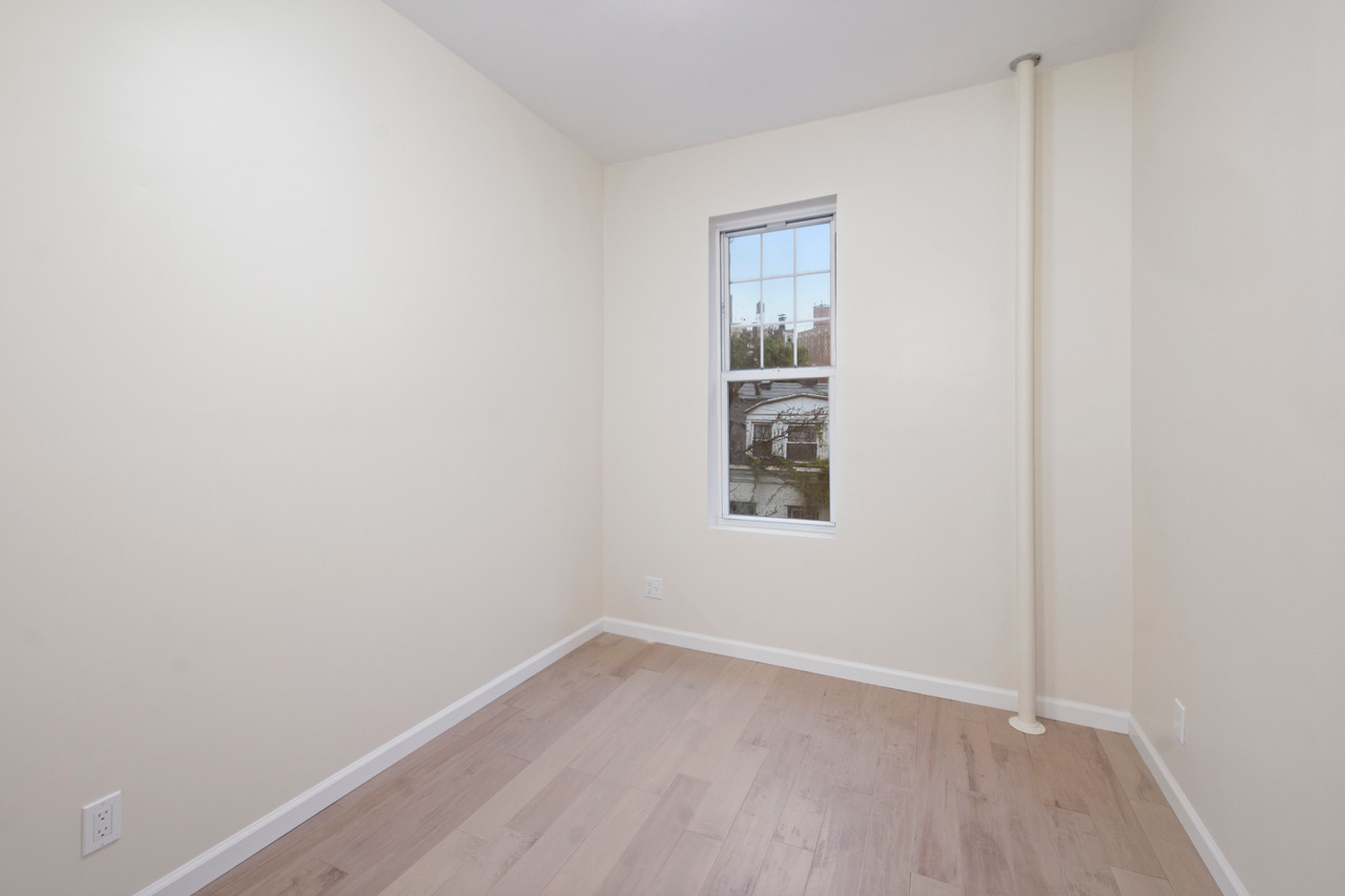 19 Christopher Street, Unit 9 Manhattan, NY 10014 - Photo 4 of 8 a view of a small space with wooden floor and a window