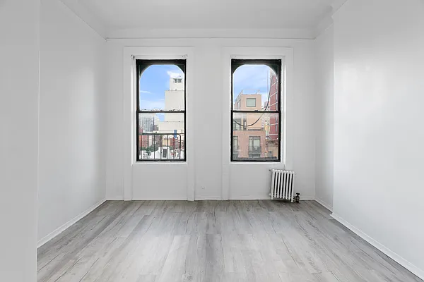824 9th Avenue, Unit 5RN Manhattan, NY 10019 - Photo 2 of 11 an empty room with windows