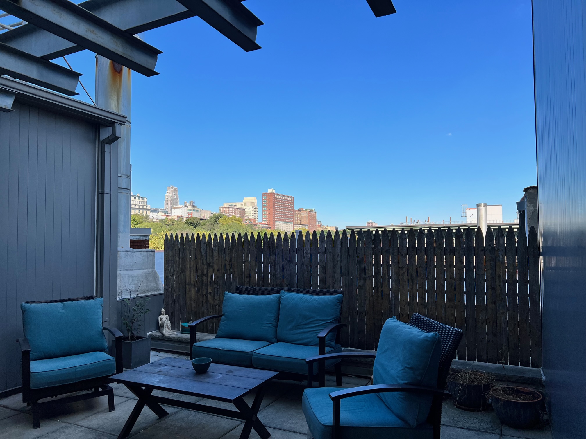 250 Manhattan Avenue, Unit 3A Manhattan, NY 10026 - Photo 11 of 15 a roof deck with a chair and a fireplace