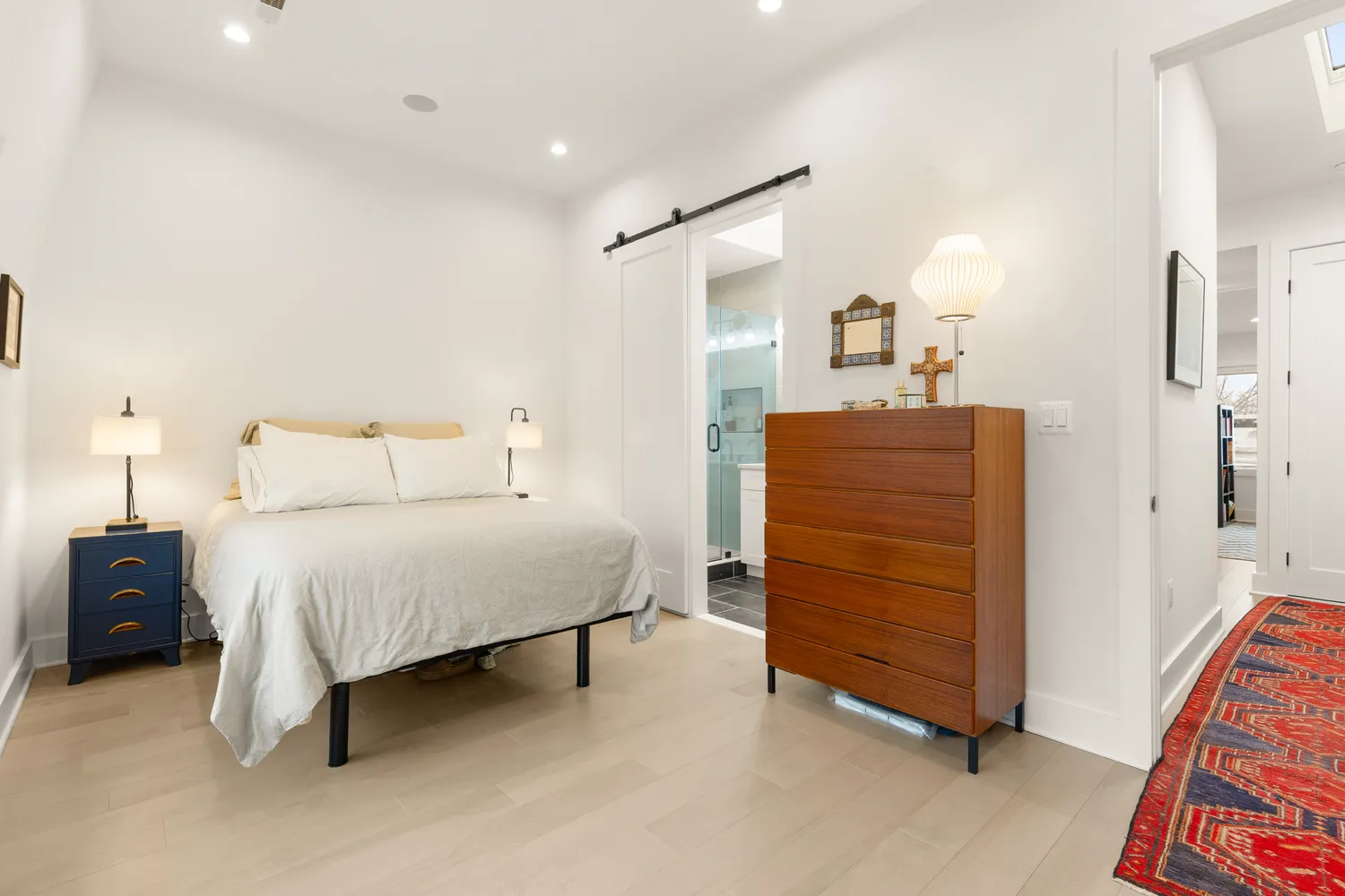 a bedroom with a bed and a dresser