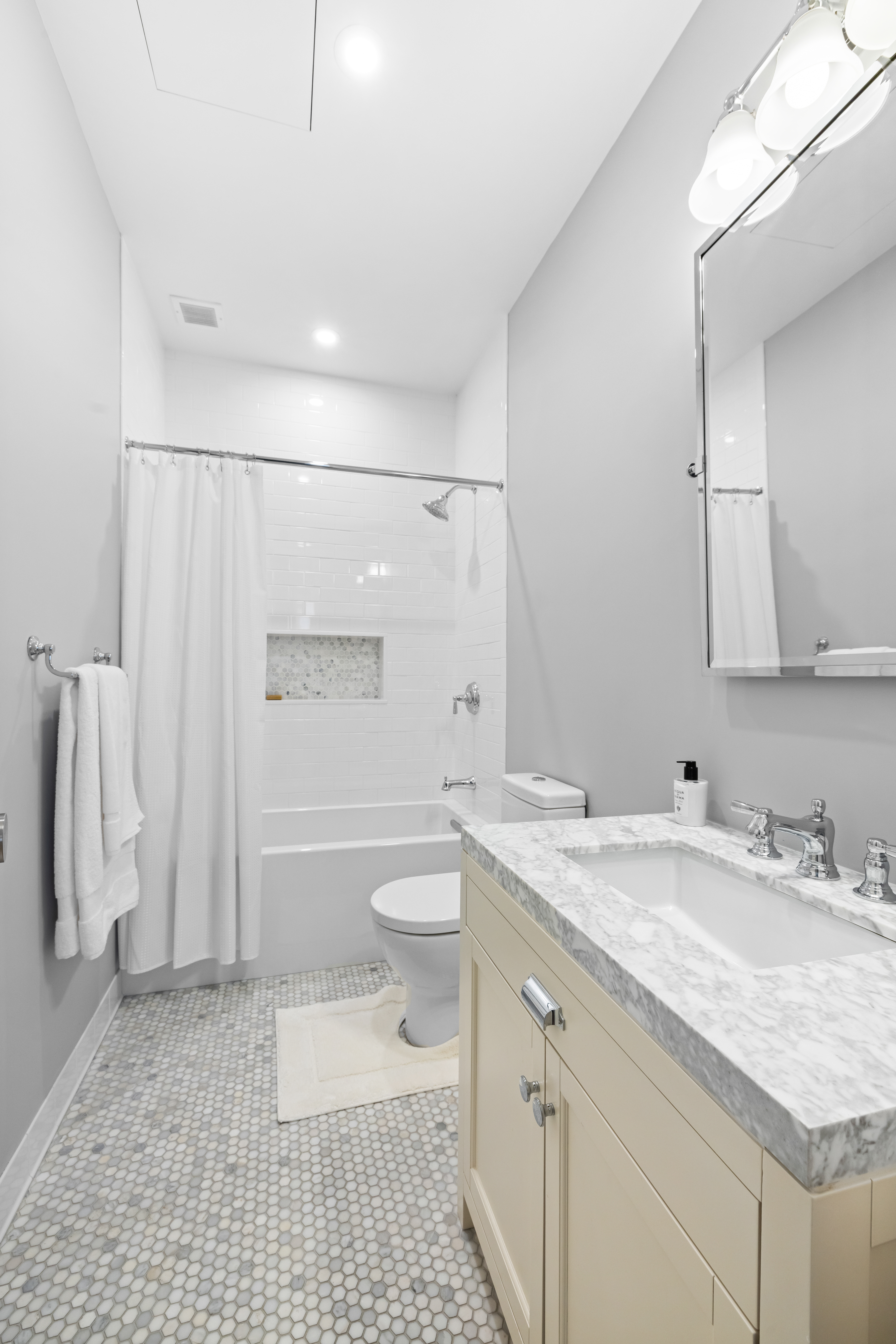 222 Park Avenue South, Unit 8D Manhattan, NY 10003 - Photo 6 of 9 a bathroom with a sink a toilet and a shower