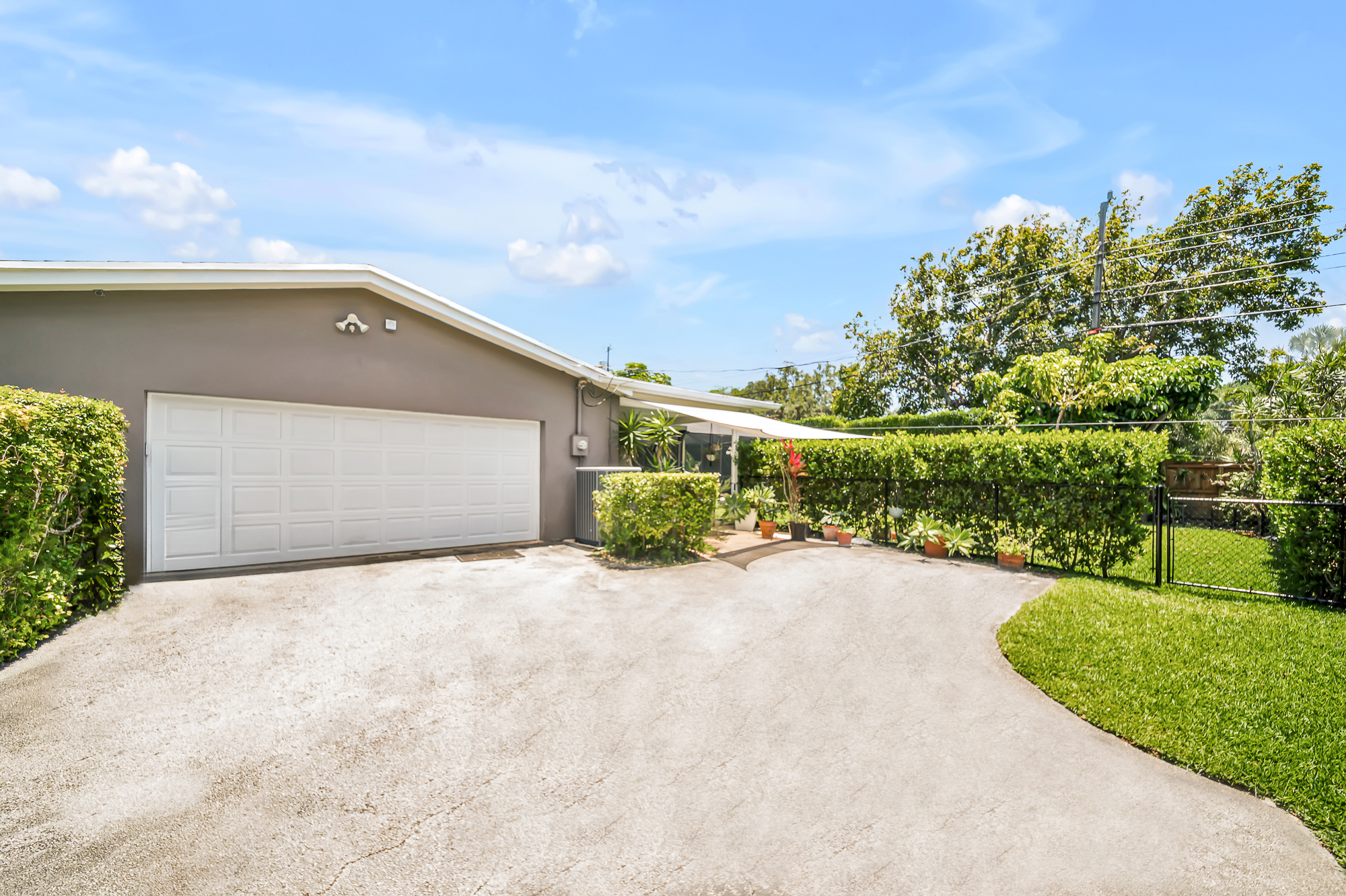 6760 Southwest 62nd Terrace Miami, FL 33143 - Photo 16 of 38 a front view of a house with a yard and garage