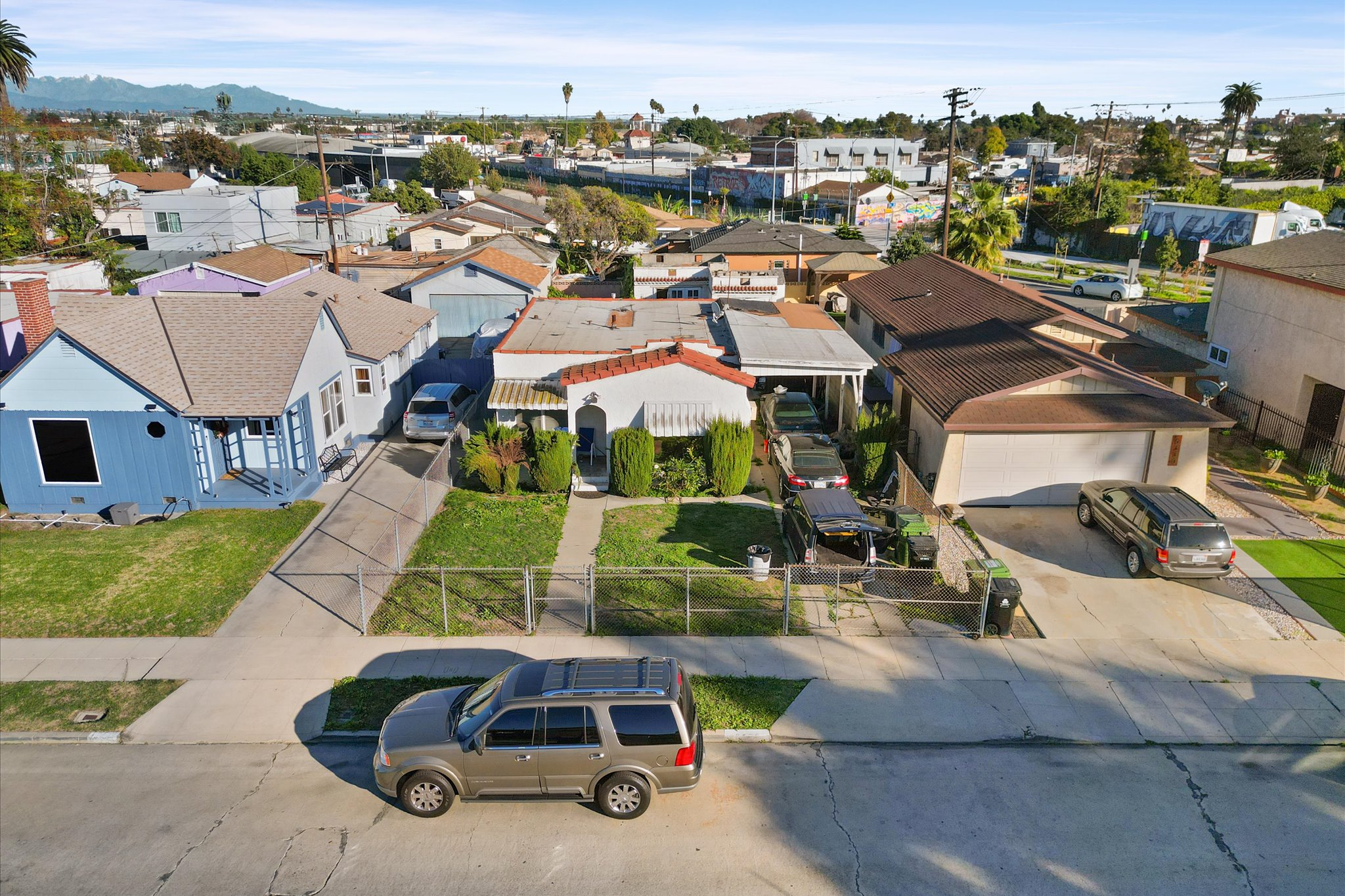 an aerial view of a house with a garden and lake view