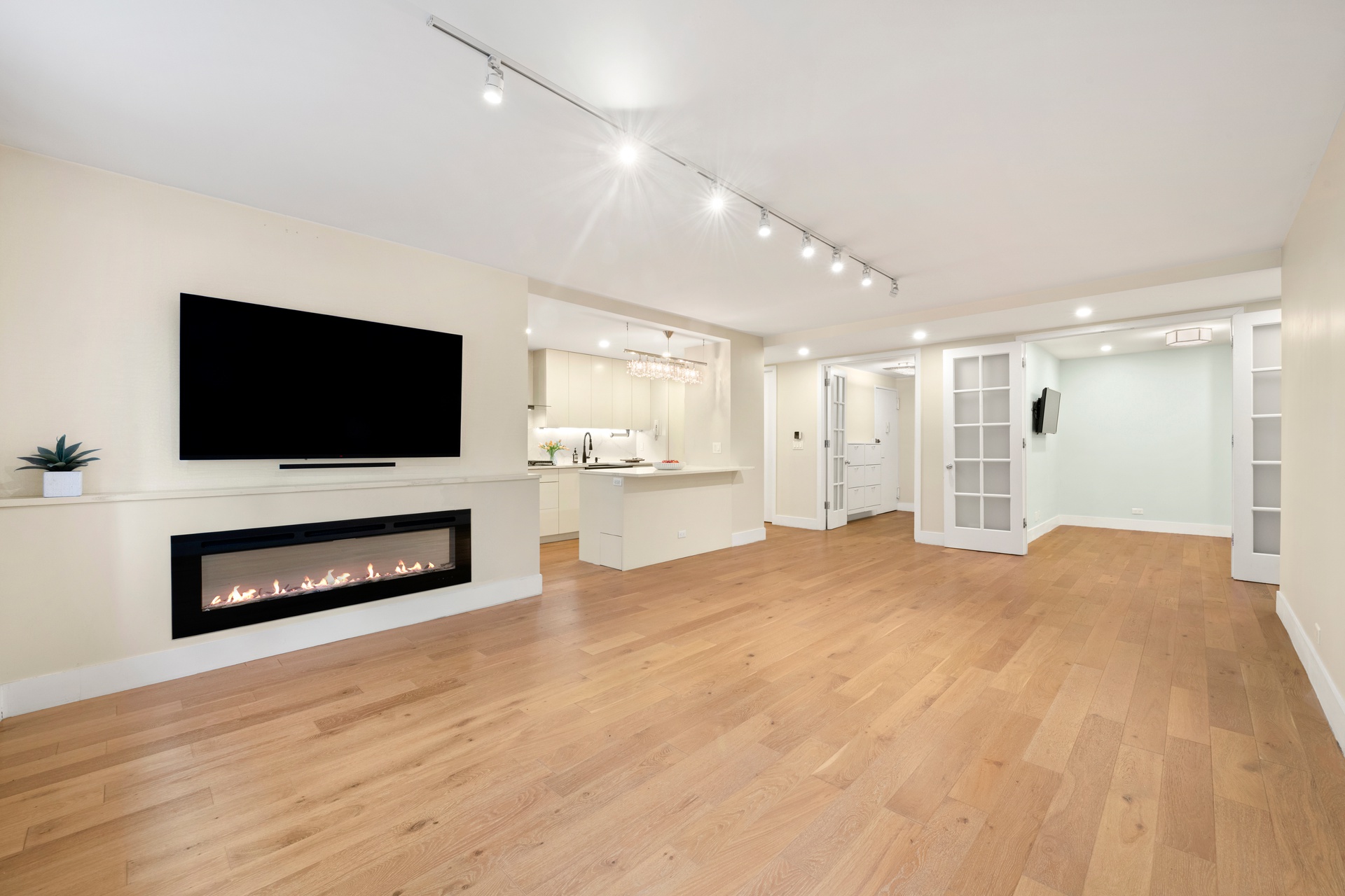 70 East 10th Street, Unit 4V Manhattan, NY 10003 - Photo 4 of 26 a view of a livingroom with a flat screen tv and a fireplace