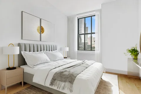 a bedroom with bed and window