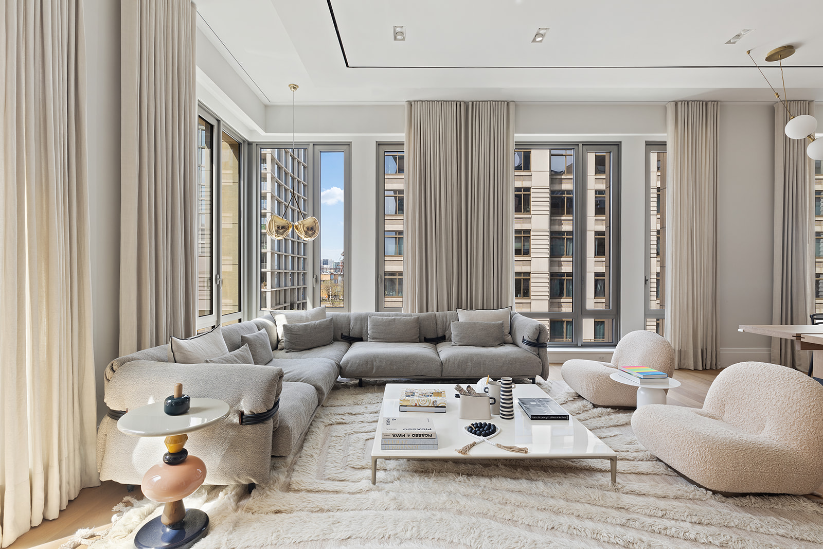 a living room with furniture and large windows