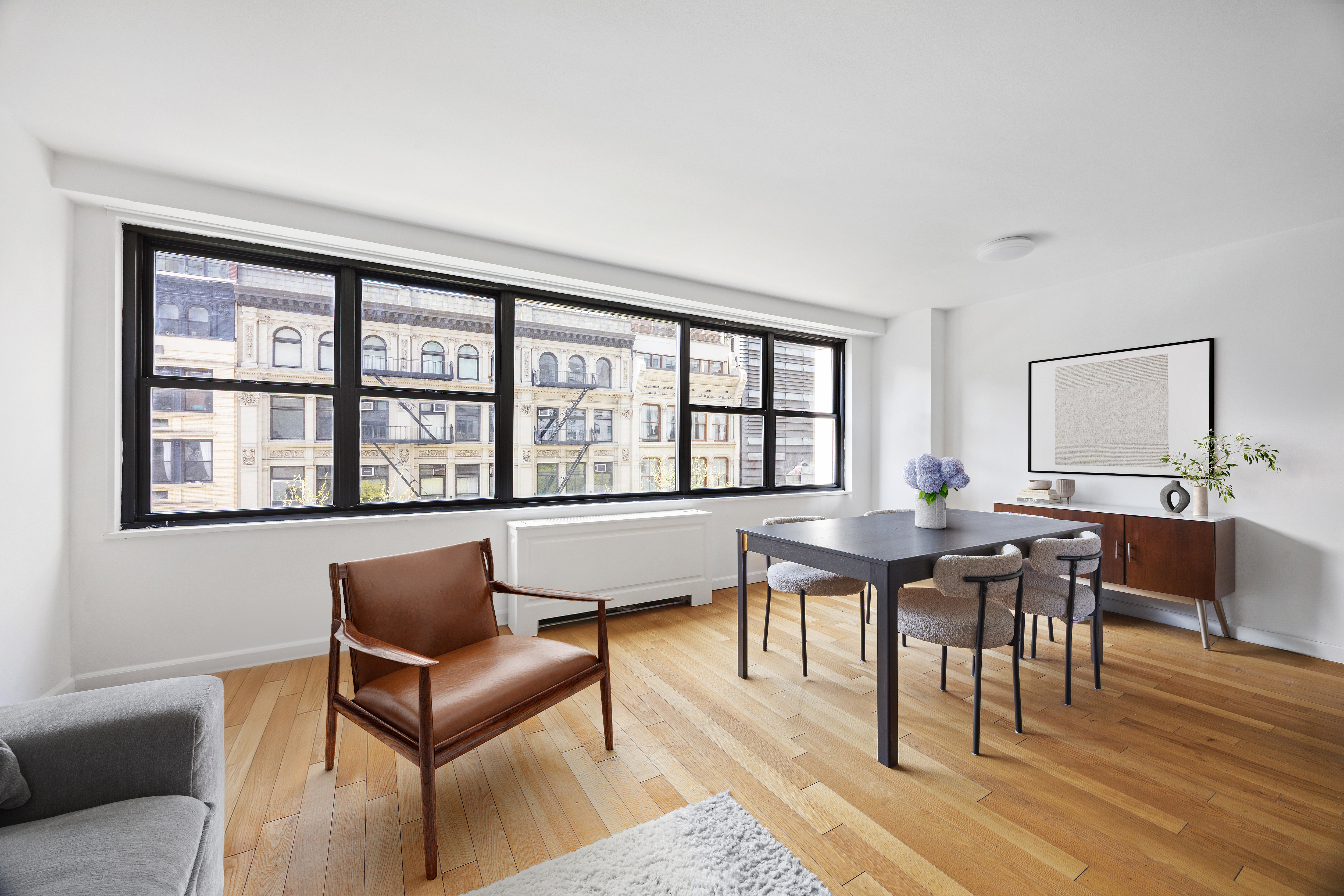 7 East 14th Street, Unit 605 Manhattan, NY 10003 - Photo 2 of 8 a view of a livingroom with furniture and wooden floor