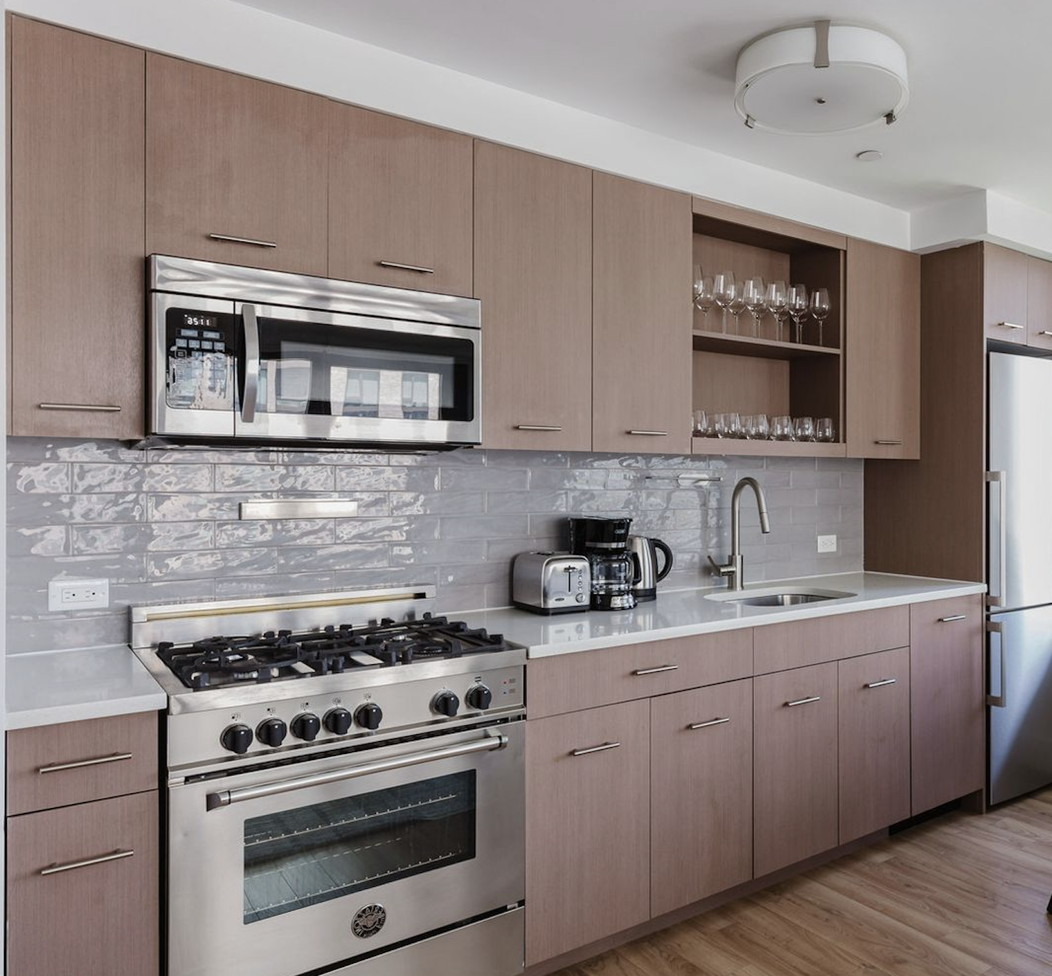 145 Clinton Street, Unit 4N Manhattan, NY 10002 - Photo 2 of 18 a kitchen with stainless steel appliances granite countertop a stove and cabinets