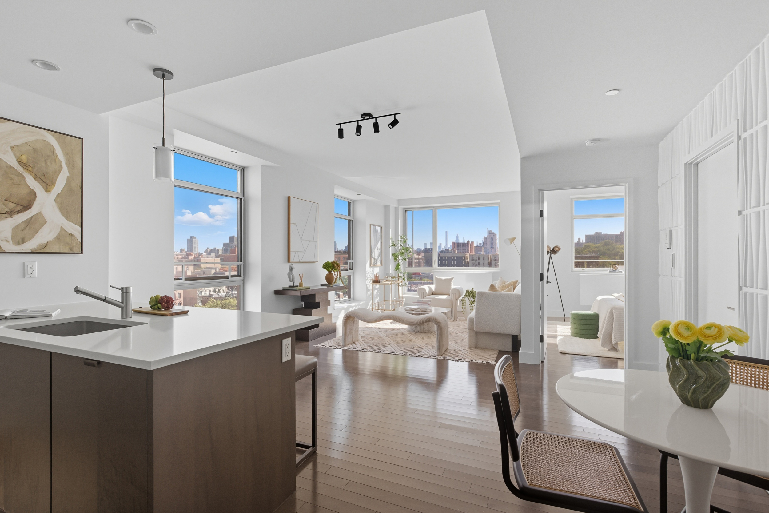88 Morningside Avenue, Unit 8G Manhattan, NY 10027 - Photo 1 of 13 a view of a dining room and livingroom with furniture wooden floor a rug a potted plant