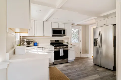 a kitchen with stainless steel appliances a refrigerator stove and microwave