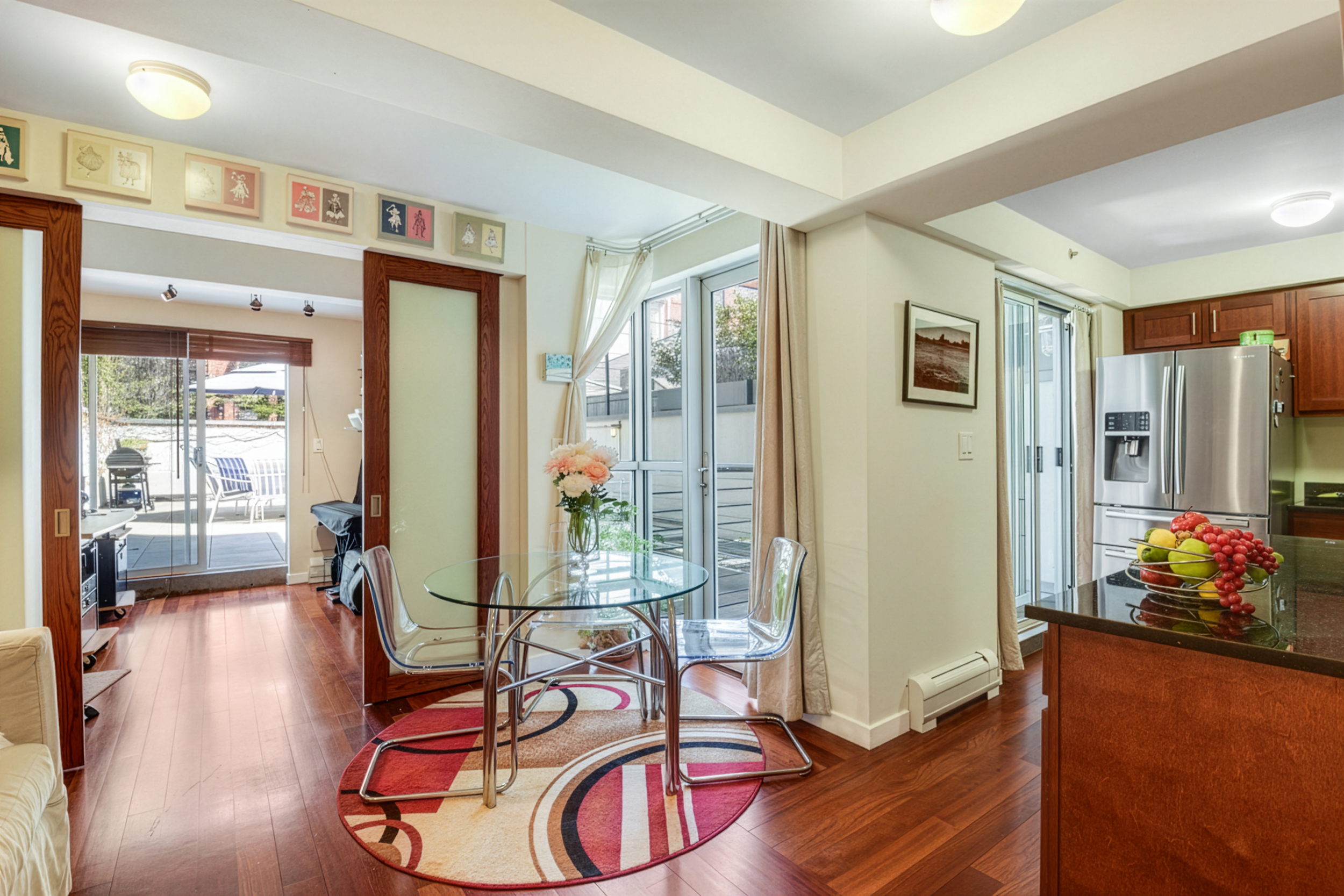 335 Warren Street, Unit 102 Brooklyn, NY 11201 - Photo 2 of 20 a living room with furniture gym equipment and large windows