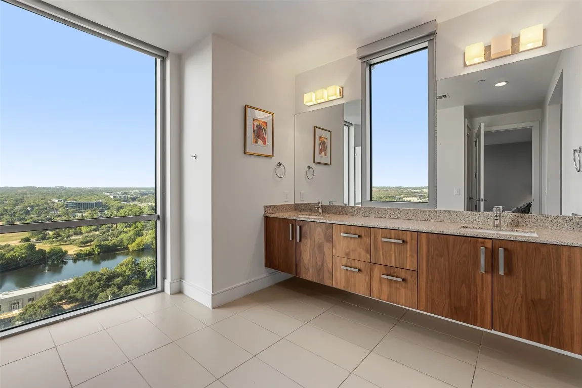 a spacious bathroom with a granite countertop sink and a large mirror