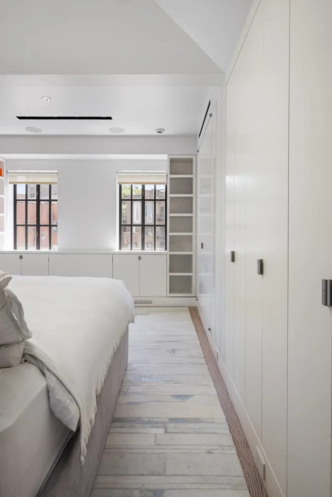 a spacious bedroom with a bed and window