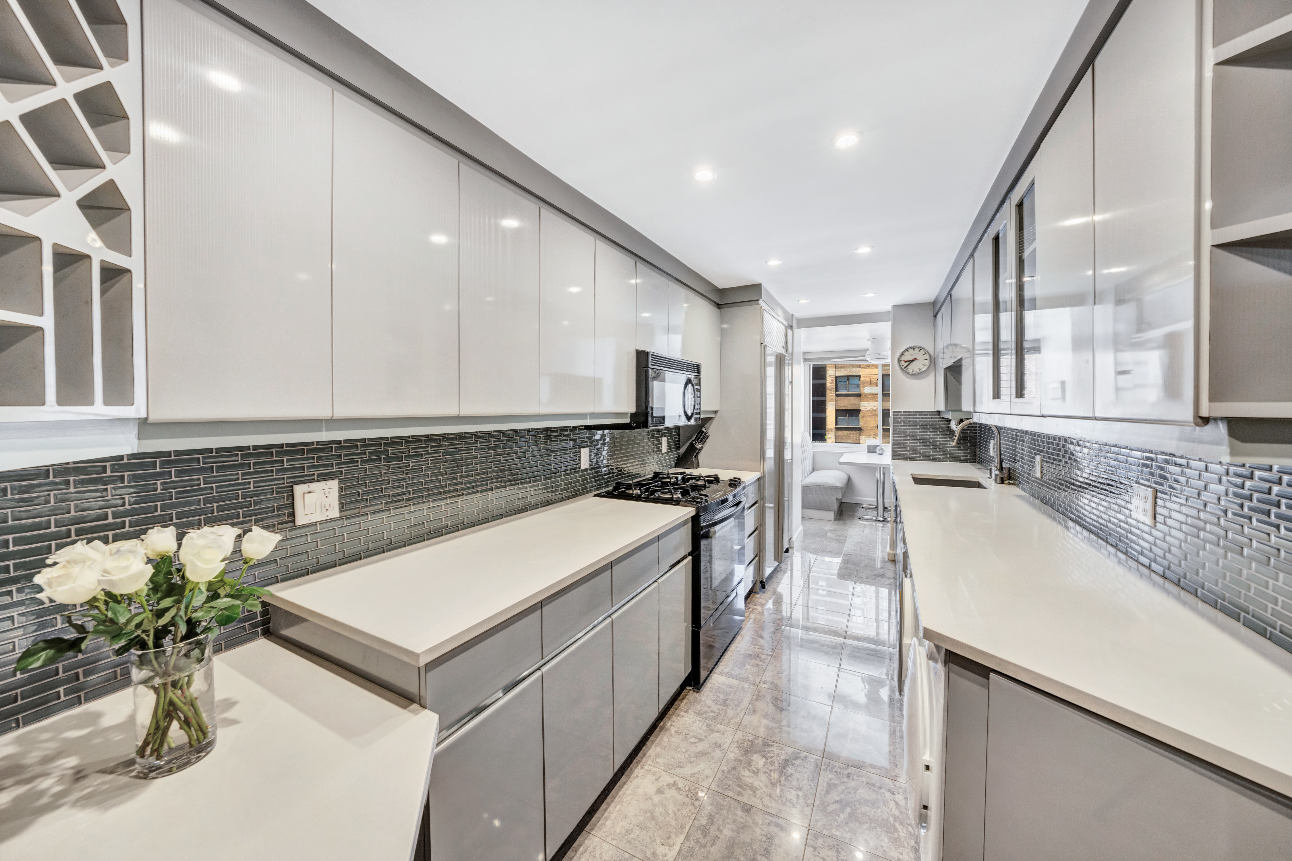 35 Sutton Place, Unit 7E Manhattan, NY 10022 - Photo 6 of 18 a large white kitchen with a large window