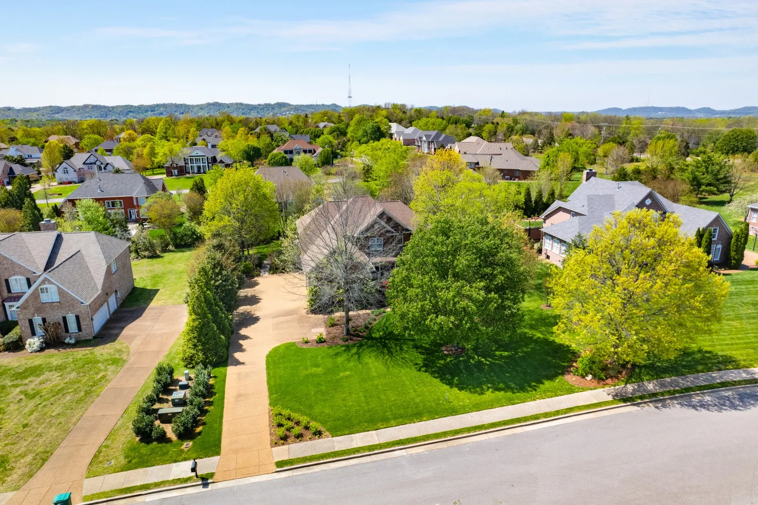 an aerial view of residential houses with outdoor space and street view