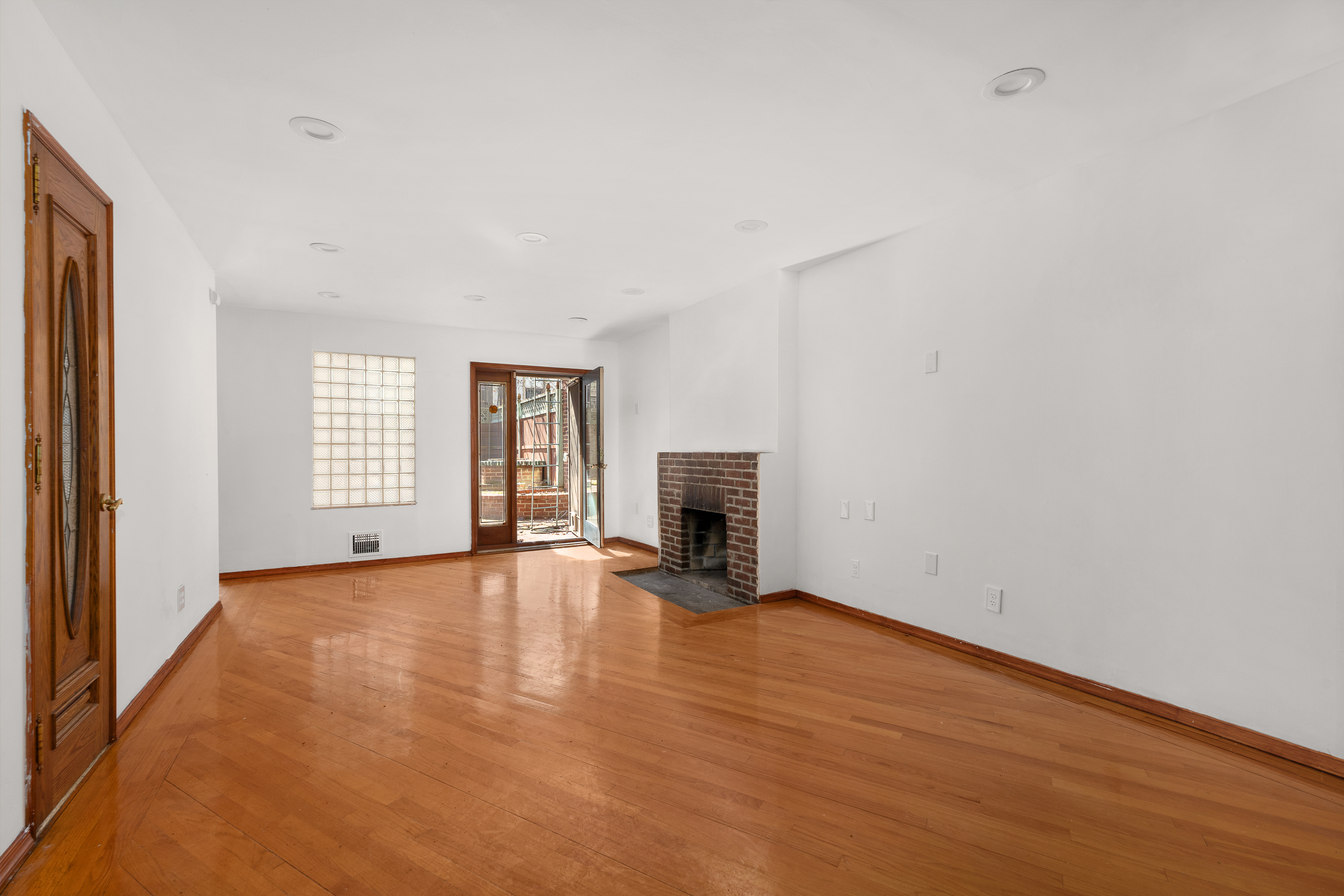 420 8th Street Brooklyn, NY 11215 - Photo 15 of 20 a view of empty room with wooden floor and fireplace
