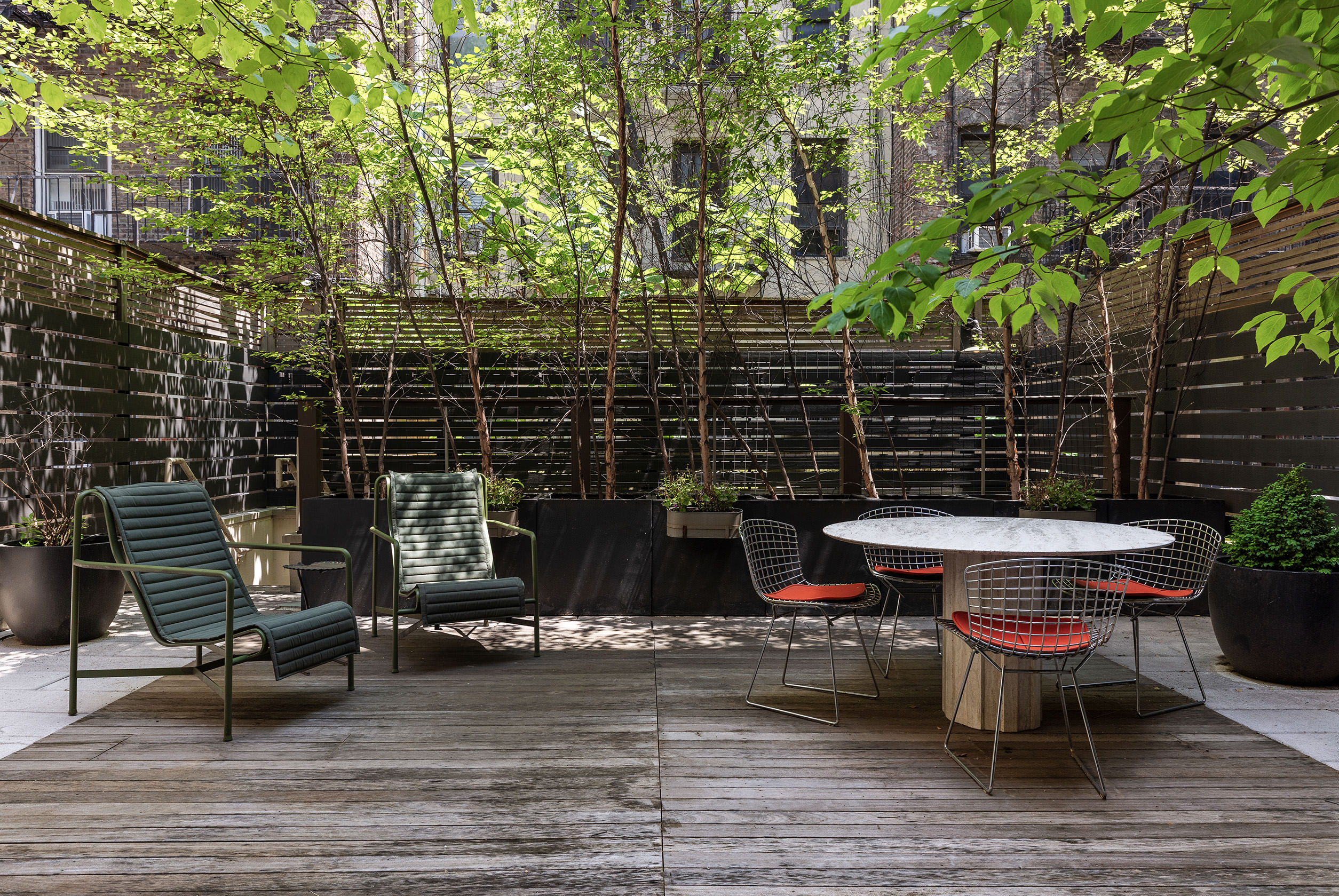 54 MacDougal Street, Unit 1 Manhattan, NY 10012 - Photo 12 of 23 a backyard of a house with table and chairs