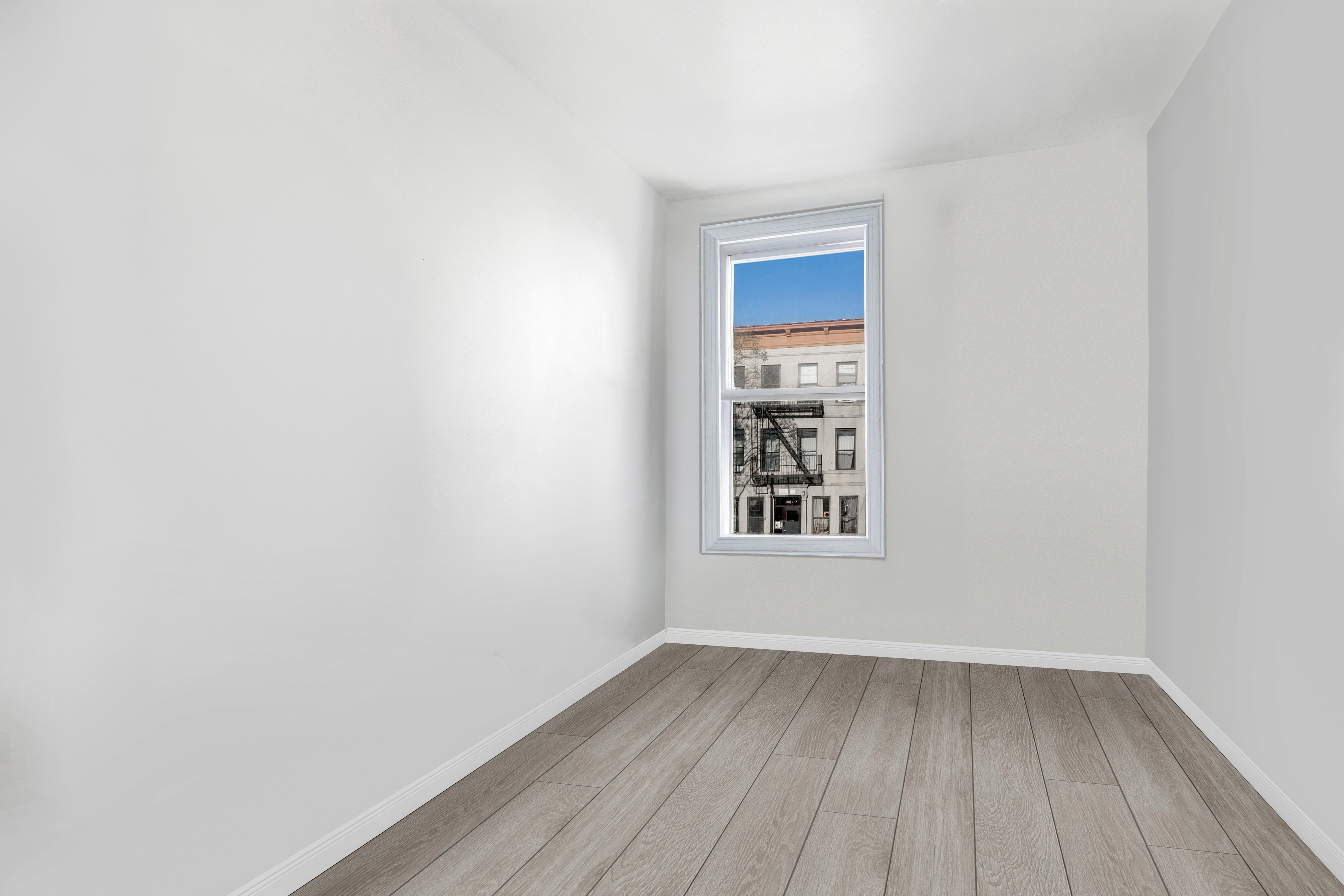 364 Chauncey Street Brooklyn, NY 11233 - Photo 13 of 17 a view of an empty room with wooden floor and a window