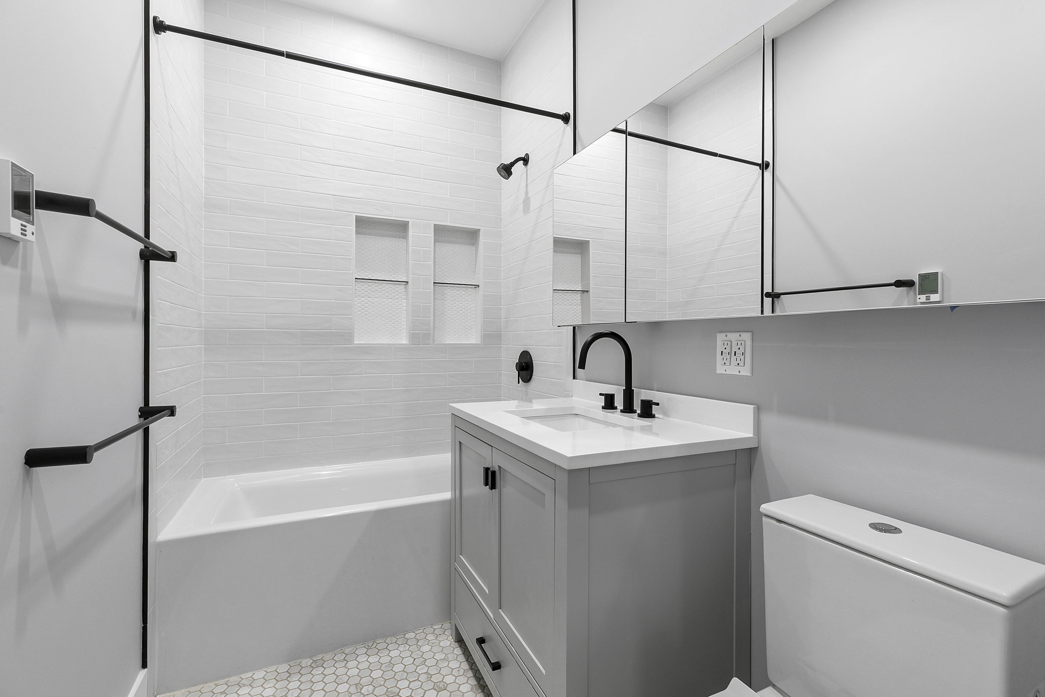 434 Throop Avenue, Unit 2 Brooklyn, NY 11221 - Photo 13 of 20 a bathroom with a sink and mirror with bathtub