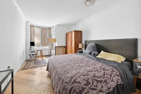 a bedroom with furniture and a flat screen tv