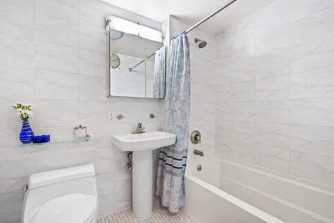 a bathroom with a sink a toilet and bathtub