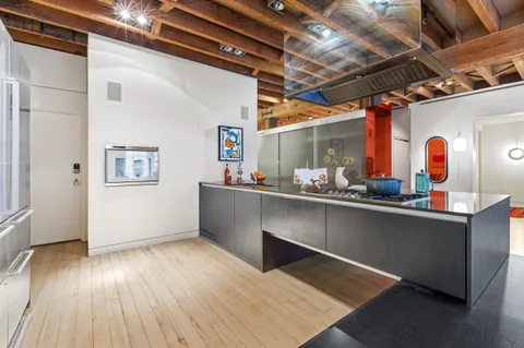 a room with wooden floors and wooden cabinets