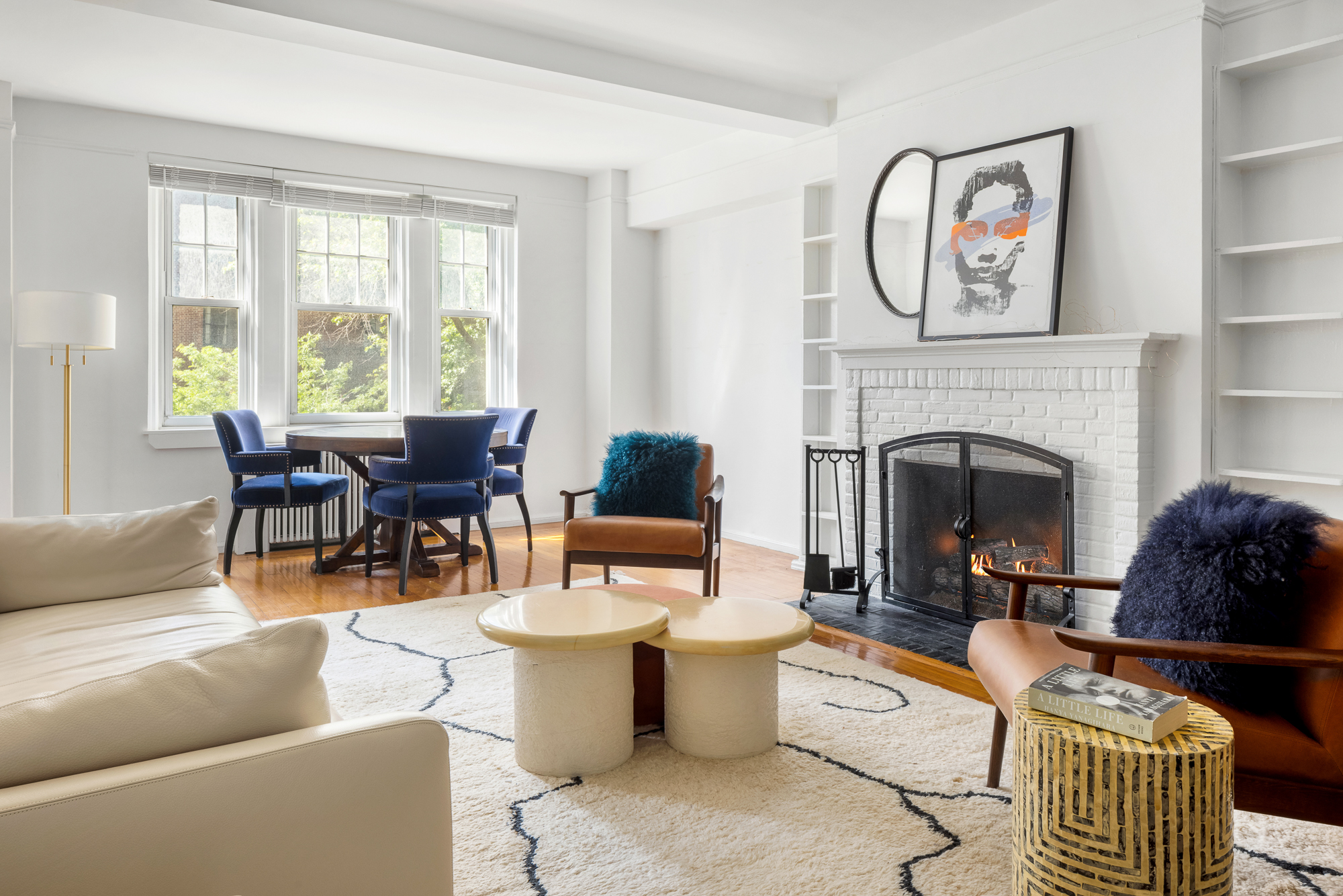 45 Christopher Street, Unit 3C Manhattan, NY 10014 - Photo 2 of 11 a living room with furniture a fireplace and a large window