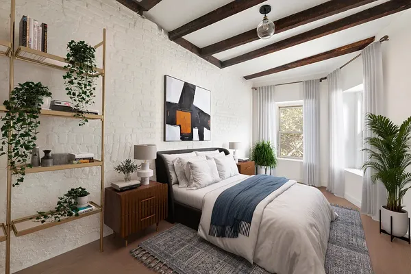 a bedroom with a bed and a potted plant