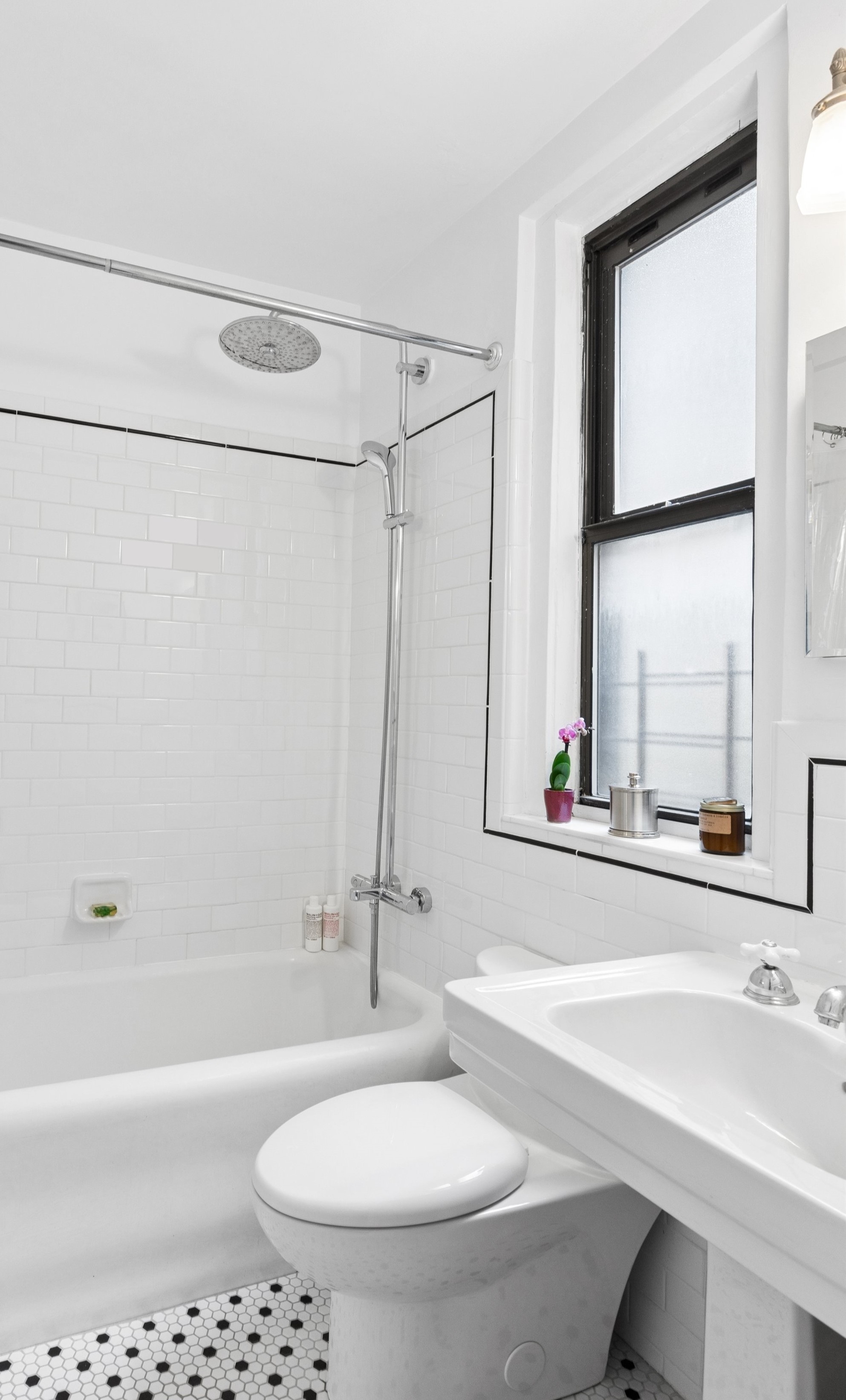 41 West 72nd Street, Unit 15E Manhattan, NY 10023 - Photo 9 of 12 a bathroom with a sink a toilet and a bathtub