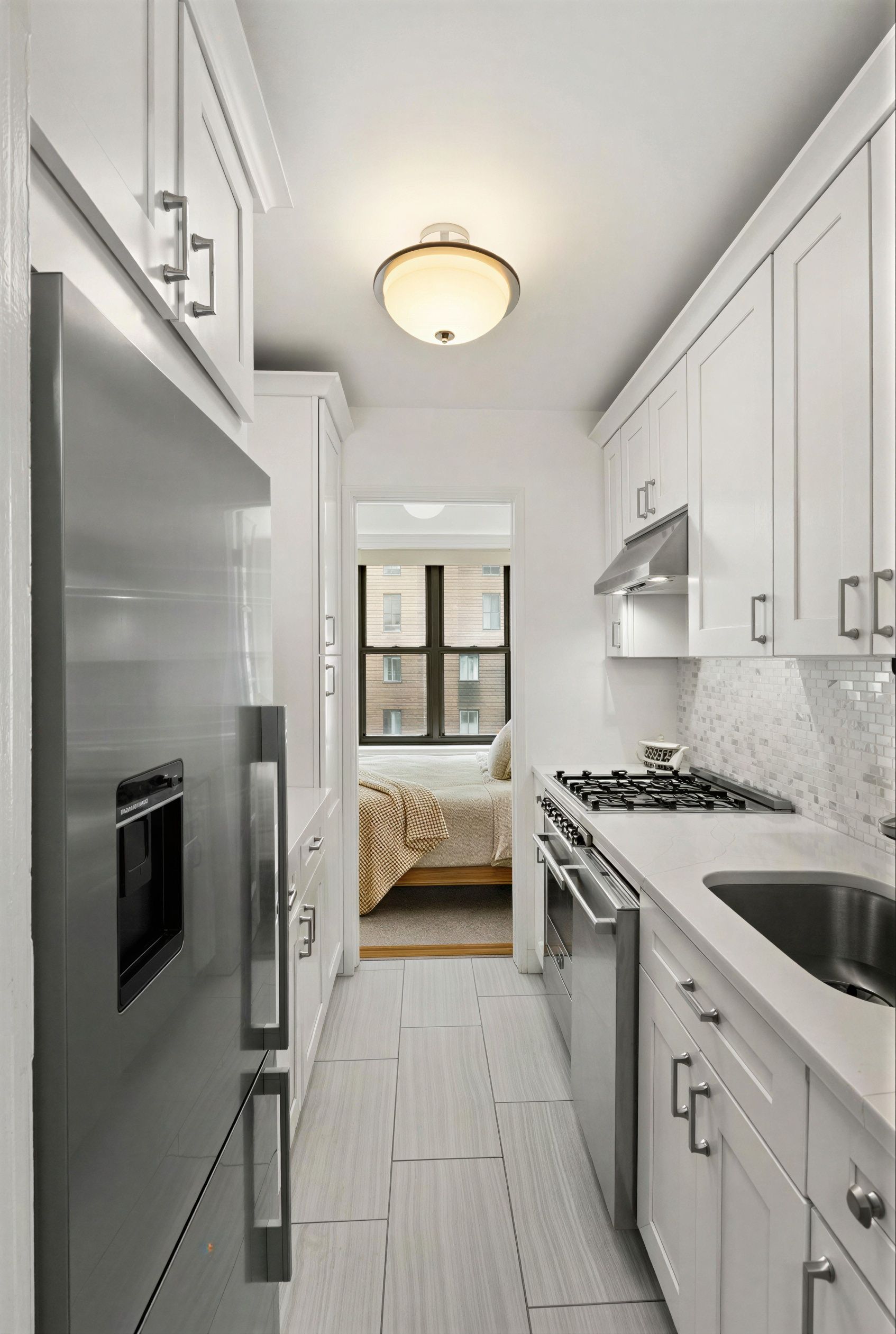 310 Lexington Avenue, Unit 9F Manhattan, NY 10016 - Photo 5 of 12 a kitchen with a stove a refrigerator and a sink