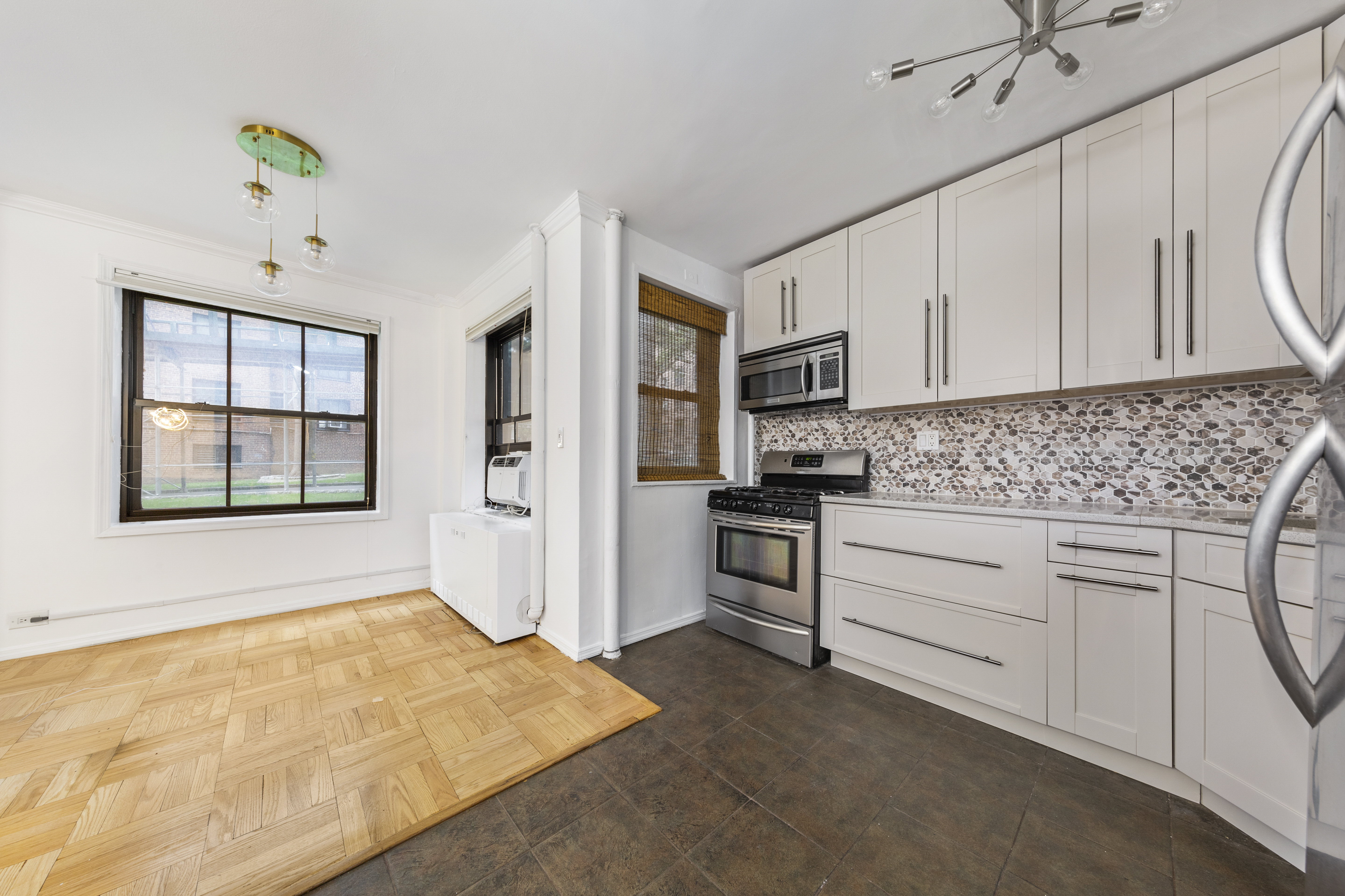 355 Clinton Avenue, Unit F1 Brooklyn, NY 11238 - Photo 5 of 20 a kitchen with granite countertop a stove a sink and a refrigerator