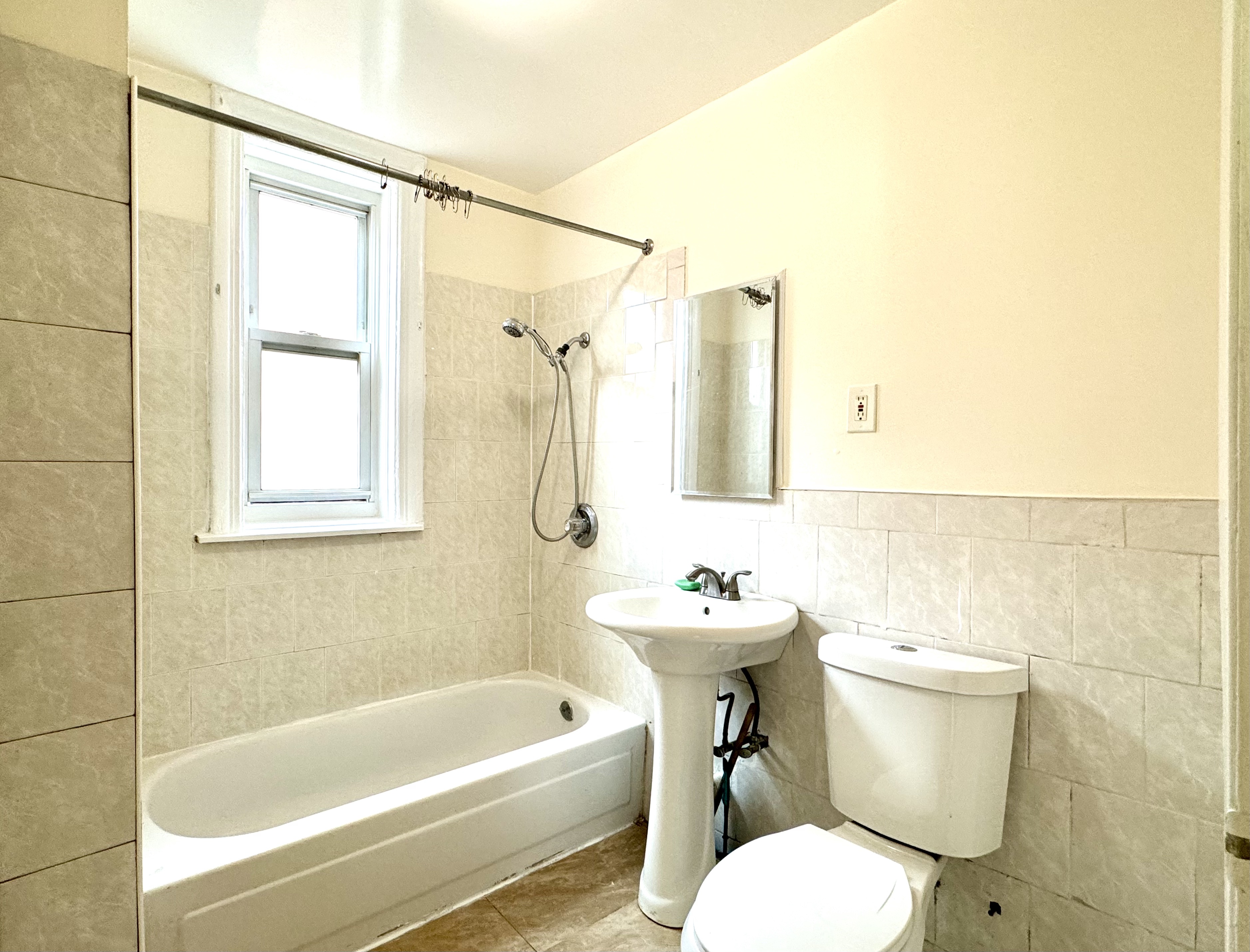 1688 Carroll Street, Unit 2 Brooklyn, NY 11213 - Photo 8 of 9 a bathroom with a sink toilet and shower