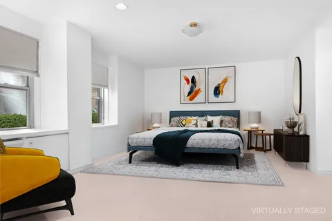 a bedroom with a bed couch and a window