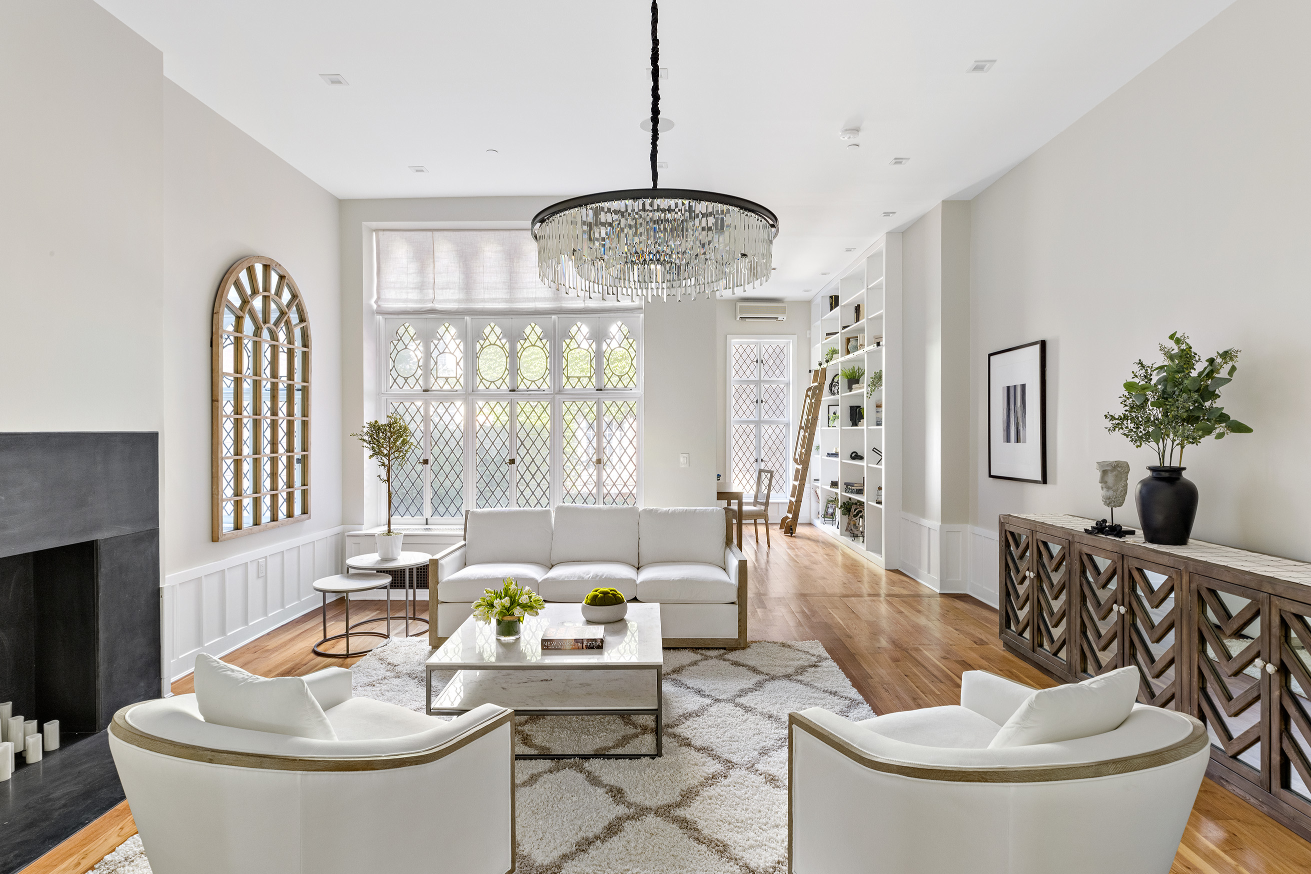 25 East 94th Street Manhattan, NY 10128 - Photo 6 of 33 a living room with furniture and a large window