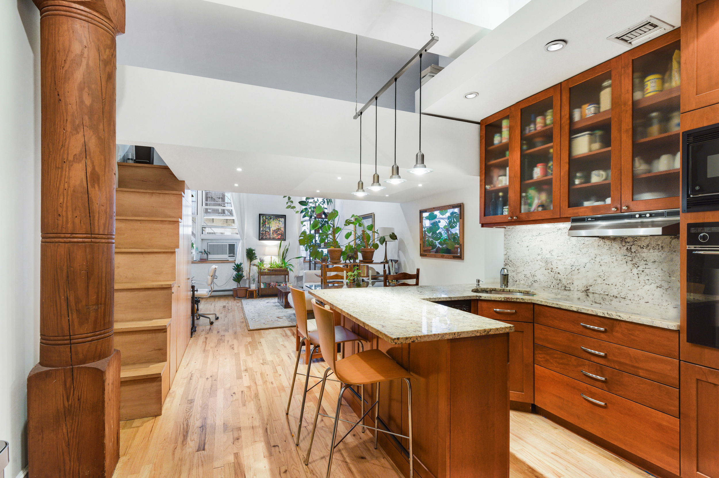 23 Waverly Place, Unit 5U Manhattan, NY 10003 - Photo 4 of 13 a kitchen with stainless steel appliances granite countertop a sink and cabinets
