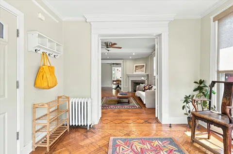 a view of a bedroom with wooden floor and a potted plant