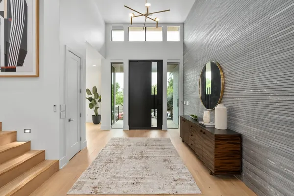 a hall way with furniture and a mirror