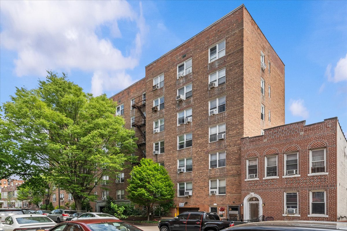 759 East 10th Street, Unit 7H Brooklyn, NY 11230 - Photo 14 of 15 a front view of a building with lot of cars and trees