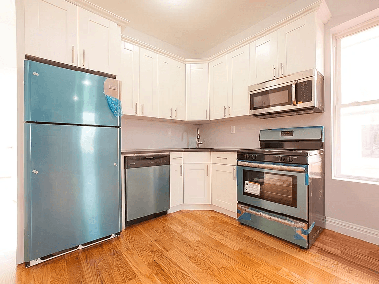 581 Van Siclen Avenue Brooklyn, NY 11207 - Photo 10 of 16 a kitchen with a refrigerator stove and microwave