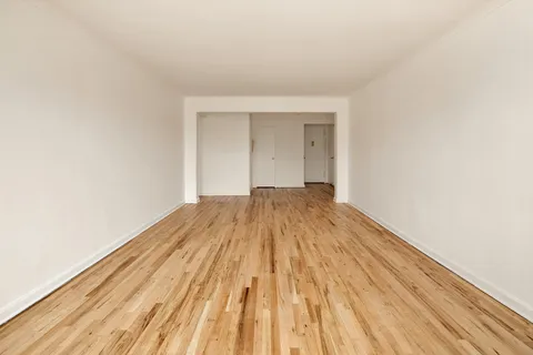 a view of a room with wooden floor and a sink