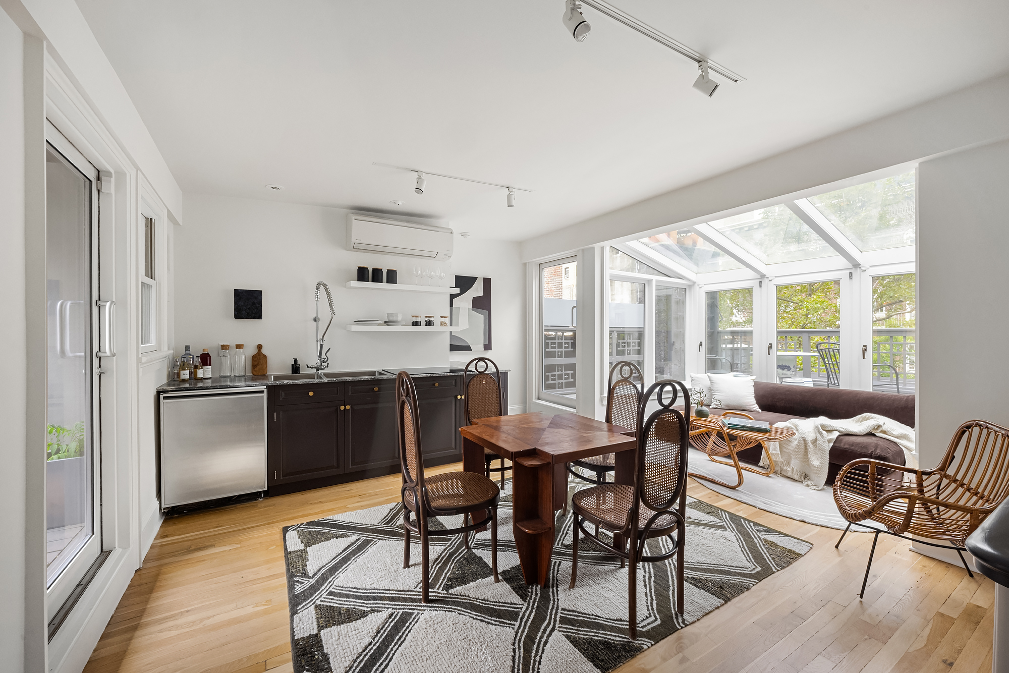 112 West 13th Street Manhattan, NY 10011 - Photo 33 of 46 a kitchen with a table chairs refrigerator and cabinets