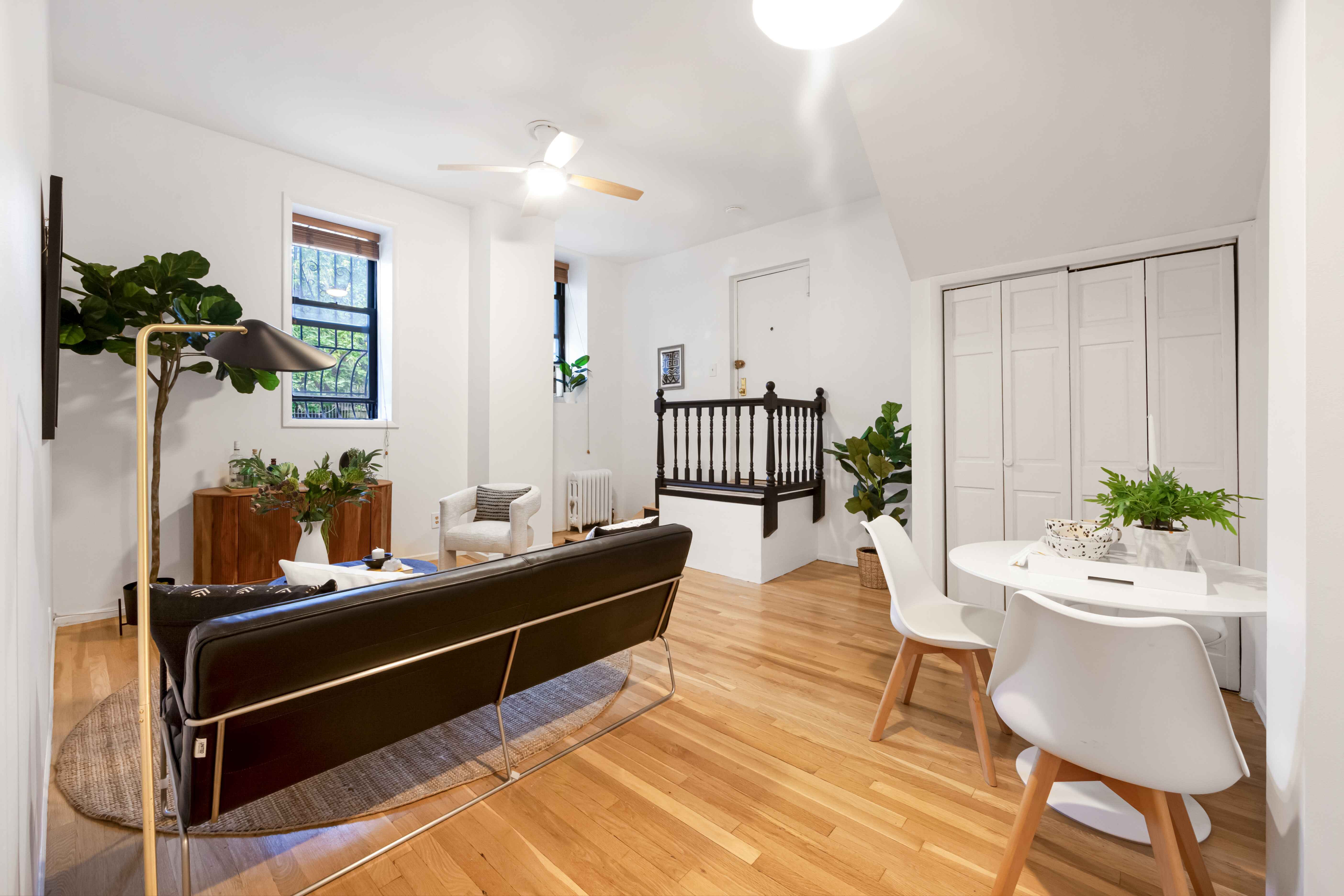 a living room with furniture and wooden floor