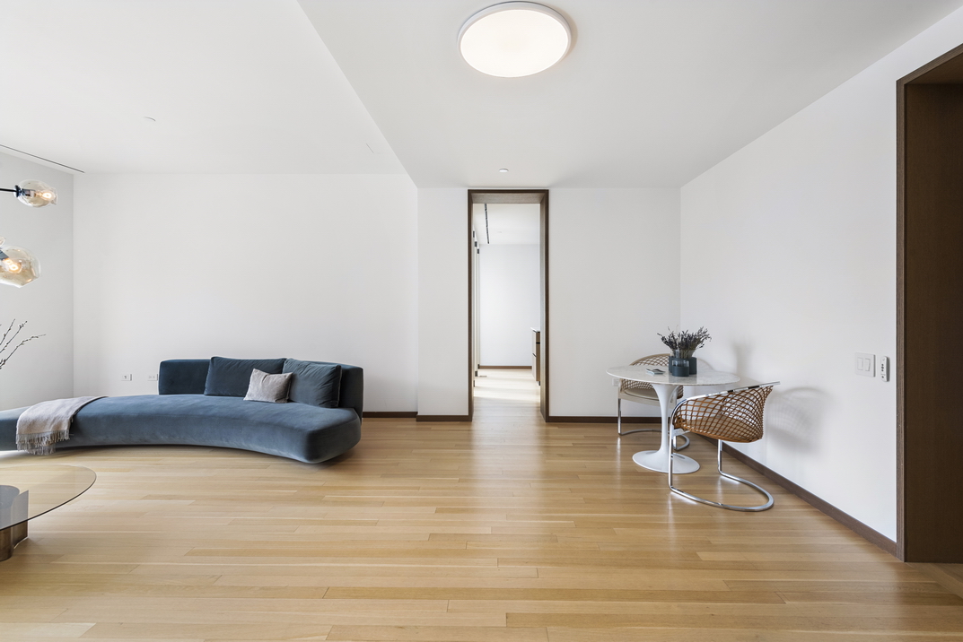 551 West 21st Street, Unit 4D Manhattan, NY 10011 - Photo 4 of 16 a living room with furniture and a wooden floor